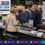 HobbyPrint stall at the Excalibur Paper Craft Show at the National Motorcycle Museum in Birmingham, displaying printers, inks, cartridges, paper and card while talking with customers.